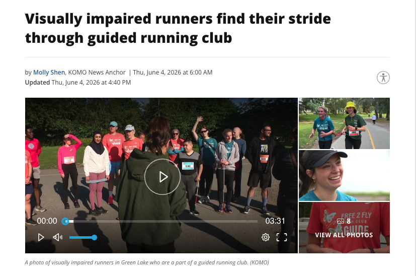 KOMO's caption (no AD provided)

A photo of visually impaired runners in Green Lake who are a part of a guided running club.

Access Hound's quick description:

Describing: A screenshot of the KOMO News website, which shows the headline of the story above a large horizontal photograph. A stack of three much-smaller horizontal photographs are to the right of the main image. All four color images are about this same "Free 2 Fly" story. 

Description: In the larger image, a woman's back is to the camera, and she faces a crowd of people, addressing them about the run they are about to do. This woman — Free 2 Fly founder Ixchel Lemus-Bromley — has her brown hair pulled into a ponytail. She is wearing a dark green hoodie and is shown from the waist up, from behind, making the crowd of runners the focal point. More than a dozen people face her and the camera. They mostly are wearing shorts or athletic leggings as well as t-shirts, with some also having light coats. They are outside with sun in their faces and grass and trees behind them. One person is raising an arm to shield the sun from her eyes. Another person is raising a hand to ask a question. 

In the three smaller images, stacked on top of each other, the top one shows two women running side-by-side, tethered at the waist to each other, on a paved path. The middle image shows a close-up portrait of Lemus-Bromley, from the shoulders up. She is wearing a baseball hat this time, with a smile on her face. The third of the three images is a muted version of a close-up photograph of a Free 2 Fly t-shirt, showing only the text on the red t-shirt and the person's arms. That image is covered by a text that reads "View All Photos" and is linked to a gallery with more images.